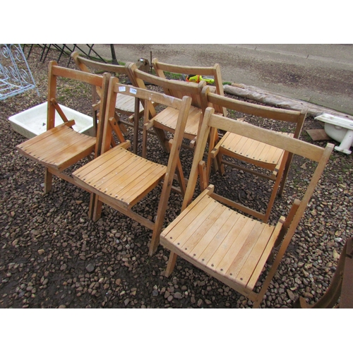 3294 - Seven folding wooden chairs