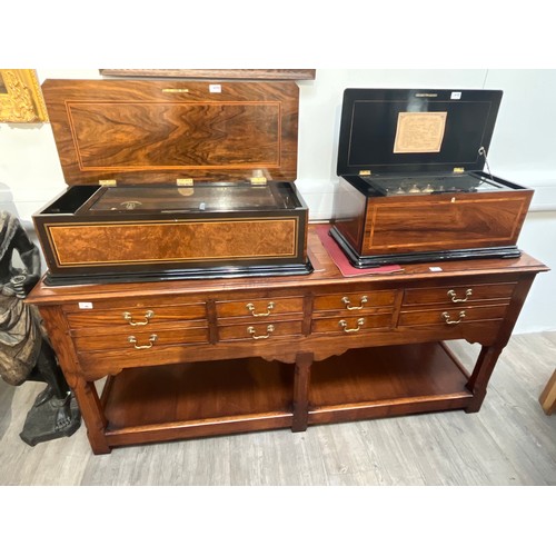 6104 - A reproduction Georgian oak sideboard, eight frieze drawers, chamfered supports joined by a stretche... 