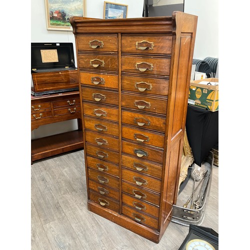 6105 - An early 20th Century oak filing cabinet set with 24 drawers, each dropping down, plinth base, 156.5... 