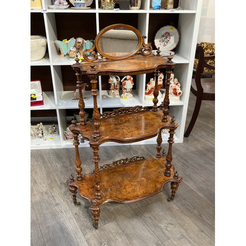 6114 - A Victorian walnut three tier what-not of graduating size with mirror to top, 107cm x 71.5cm