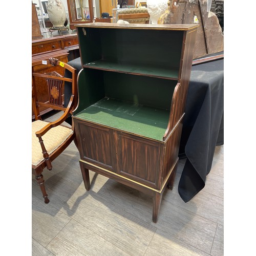 6116 - An early 20th Century waterfall bookcase with cupboard base, square tapering legs, handpainted wood ... 