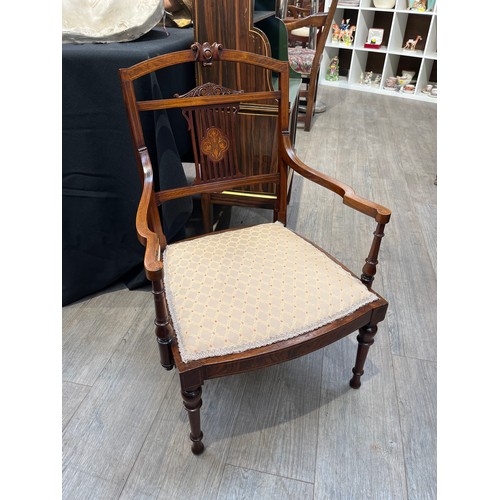 6117 - An Edwardian rosewood nursing chair, the pierced back support with central marquetry panel, on turne... 