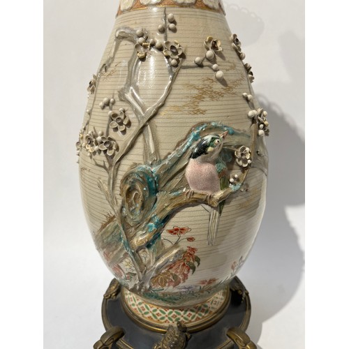 6124 - A large Japanese Satsuma vase with applied brass base and rim, decorated with applied birds and foli... 