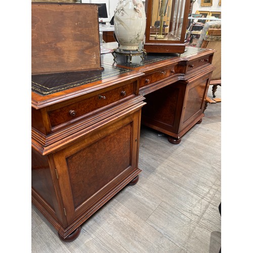 6126 - A reproduction flame walnut partner's desk, the three-section tooled leather top over a three drawer... 