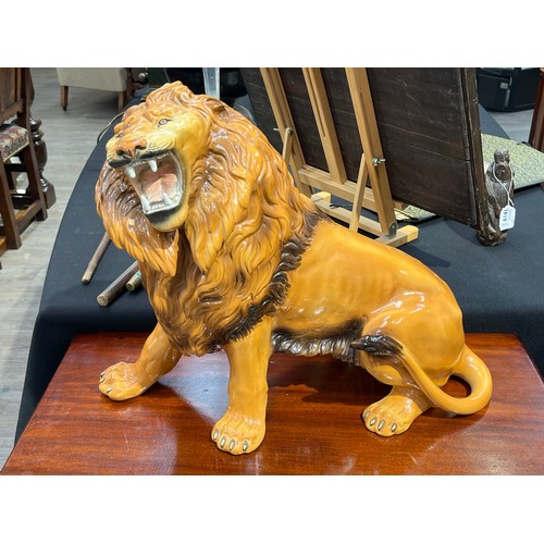 6136 - A Favaro Cecchello, Italy, figure of a lion roaring, 44cm tall, 57cm long