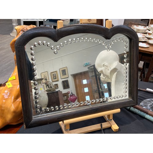 6139 - A sorcerers mirror, shaped top frame, 41.5cm x 57cm (34cm x 49.5cm mirror plate)