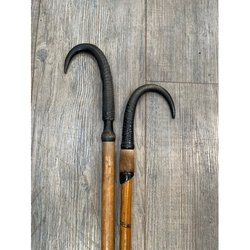 6148 - Two Alpine walking canes with antler handles, one marked Grindelwold (2) 84cm x 95cm