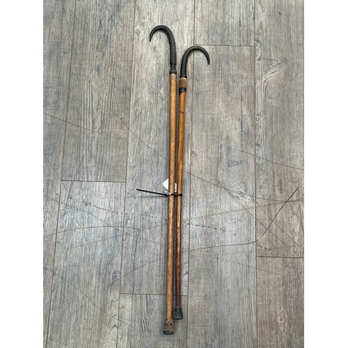 6148 - Two Alpine walking canes with antler handles, one marked Grindelwold (2) 84cm x 95cm