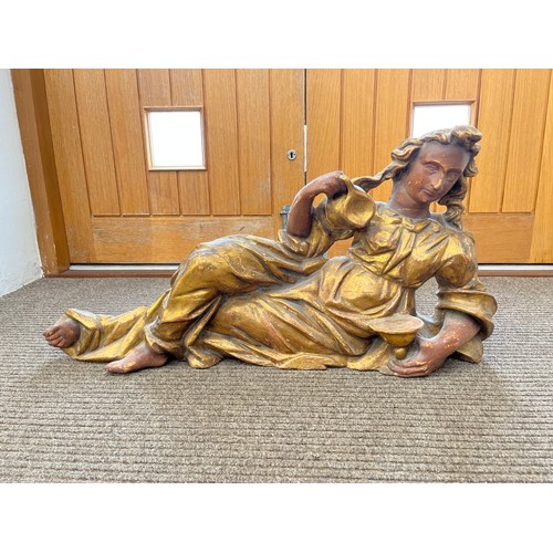 6149 - A 19th Century carved giltwood recumbent female figure holding a jug, 97cm x 46cm