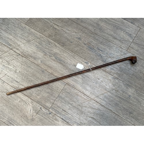 6154 - A Victorian walking cane, the handle carved as the head of a Pug, 84cm tall