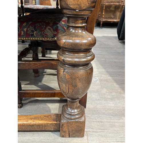 6157 - A Jacobean style country oak refectory dining table, the plank top over turned cup and cover support... 