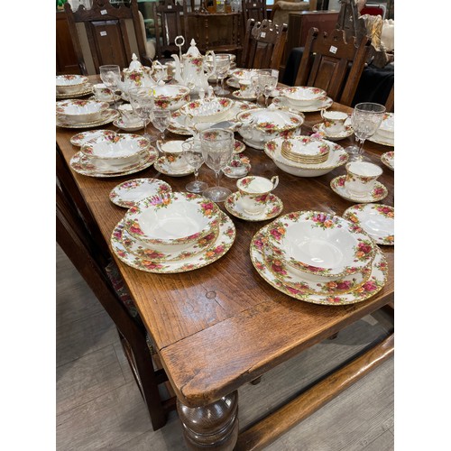 6157 - A Jacobean style country oak refectory dining table, the plank top over turned cup and cover support... 