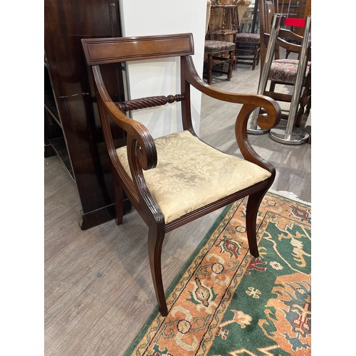 6163 - Circa 1820 a mahogany armchair with carved rope twist central bar back rest, the reeded scroll arms ... 