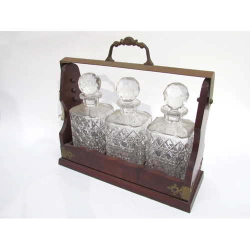 6033 - A 20th Century three bottle Tantalus, lockable with key, 36cm x 38cm