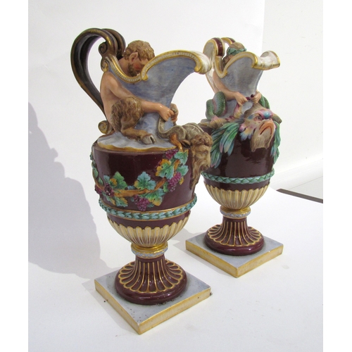 6052 - A pair of late 19th/early 20th Century Naples jugs with Merman and Pan to spout, 40cm tall, approx 2... 