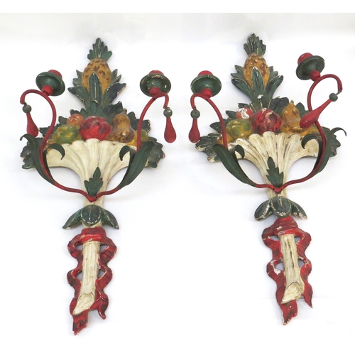 6067 - A pair of painted wool and metal wall hanging candle sconces of pineapple and fruit design, 71.5cm t... 