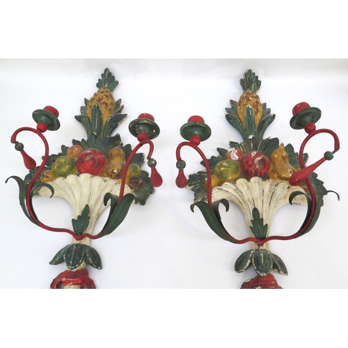 6067 - A pair of painted wool and metal wall hanging candle sconces of pineapple and fruit design, 71.5cm t... 