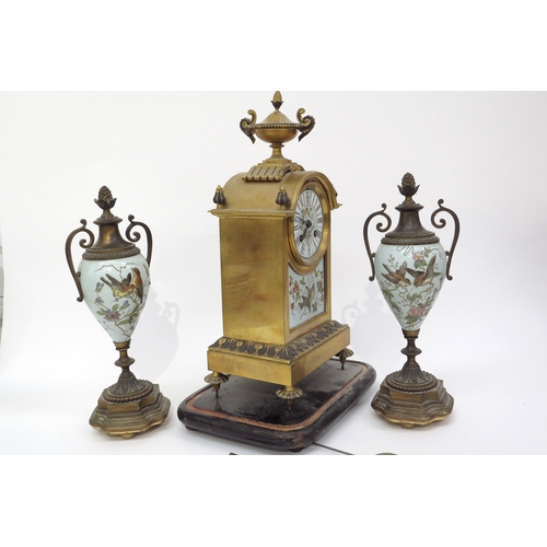 6076 - A Waterhouse & Co brass and enamel French clock garniture with bird detail, back open, 37cm x 18cm