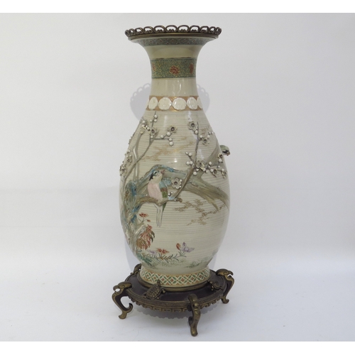 6124 - A large Japanese Satsuma vase with applied brass base and rim, decorated with applied birds and foli... 