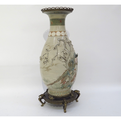 6124 - A large Japanese Satsuma vase with applied brass base and rim, decorated with applied birds and foli... 