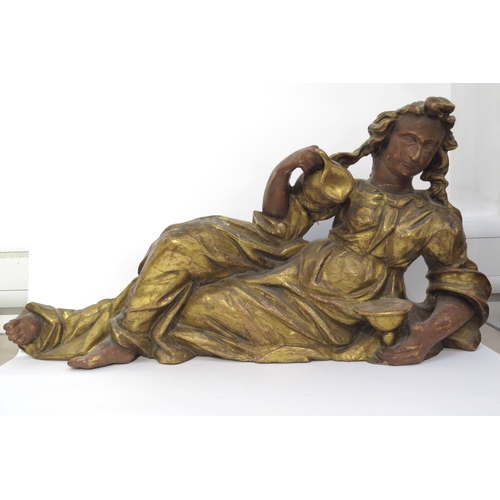 6149 - A 19th Century carved giltwood recumbent female figure holding a jug, 97cm x 46cm