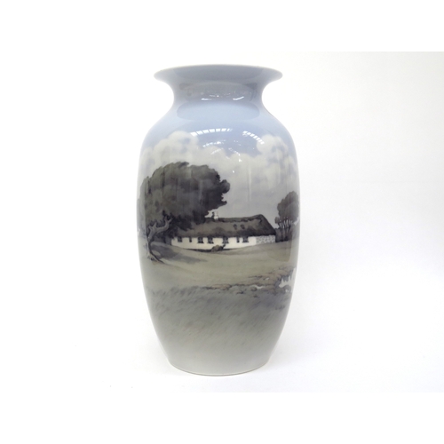 6267 - A Royal Copenhagen vase decorated with rural cottage scene, 32.5cm tall  (R)  £90