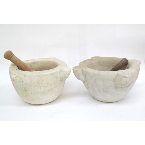 6308 - WITHDRAWN: Two large marble mortars with wooden pestles one with cracks to side approximately 30cm i... 