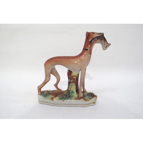 6314 - A 19th century standing Staffordshire greyhound with rabbit in mouth, 15cm tall