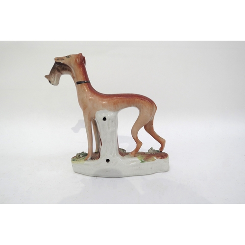 6314 - A 19th century standing Staffordshire greyhound with rabbit in mouth, 15cm tall