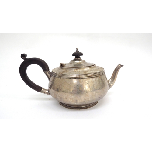 6480 - A Silver teapot with ebony knop and handle, London 1930 makers mark rubbed, 694g