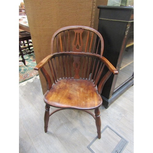 6193 - A circa 1800 elm seated Windsor hoop back chair, pierced splat, on crinoline stretcher  (C)