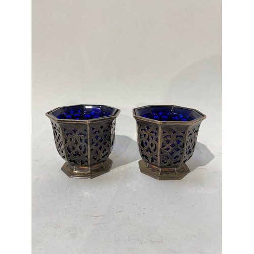 6500 - A pair of Victorian Henry Wilkinson & Co silver pierced condiment pots of octagonal form with blue g... 