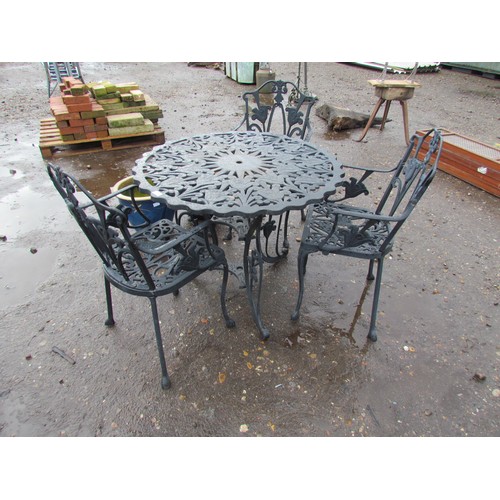 3440 - A cast alloy garden table with three chairs