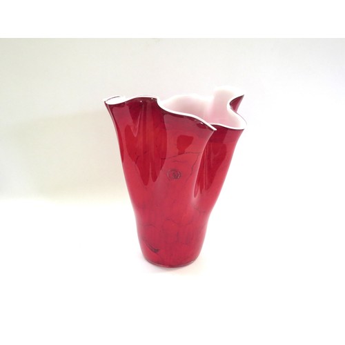 9188 - A Polish Zorza Art Glass handkerchief vase in red with black striations, white interior. 30cm high