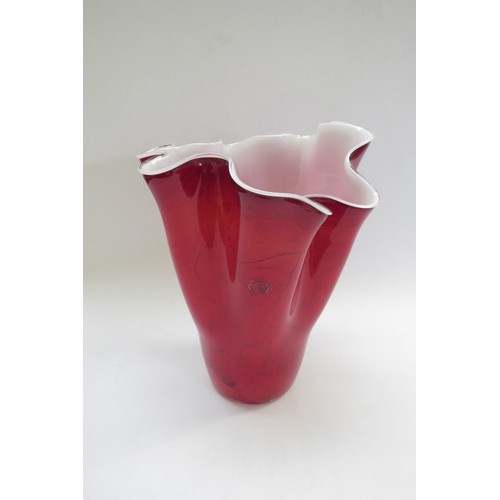 9188 - A Polish Zorza Art Glass handkerchief vase in red with black striations, white interior. 30cm high