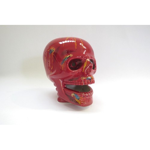 9071 - An Anita Harris Pottery skull with red and yellow glazes and blue dashes. Printed and signed marks t... 