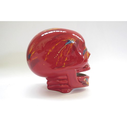 9071 - An Anita Harris Pottery skull with red and yellow glazes and blue dashes. Printed and signed marks t... 