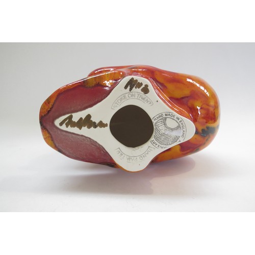 9070 - An Anita Harris Pottery skull with red and yellow glazes and black lines. Printed and signed marks t... 