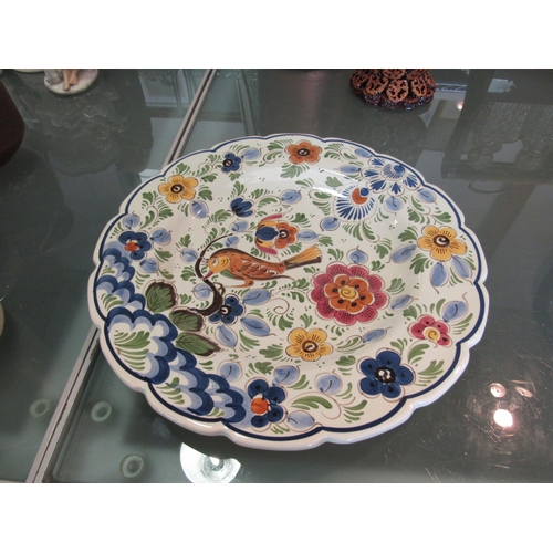 1462 - A Delft charger decorated with bird and floral sprays, 34cm diameter     (E) £10-15