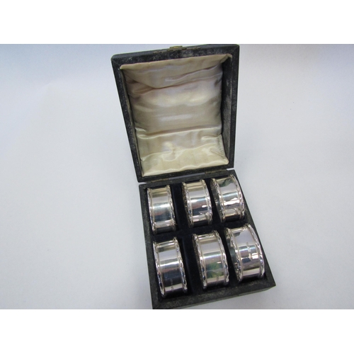 1276 - A cased set of six Clifford Brothers silver napkin rings, Birmingham 1934