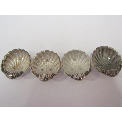 1291 - A set of four silver shell shaped salts with glass liners, Birmingham, maker A Marston & Co    (C)