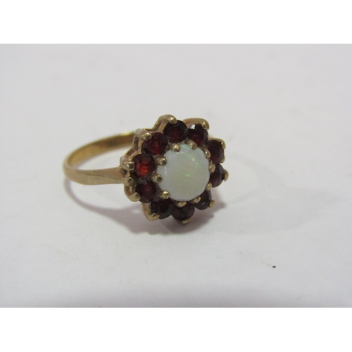 1293 - A 9ct opal and garnet set ring, size K 1/2, weight 19.g