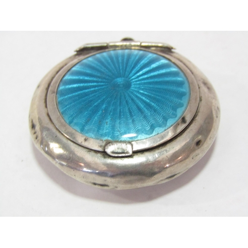 1295 - A circular silver compact pendant with blue enamel decorated lid, Birmingham 1921 (dented)