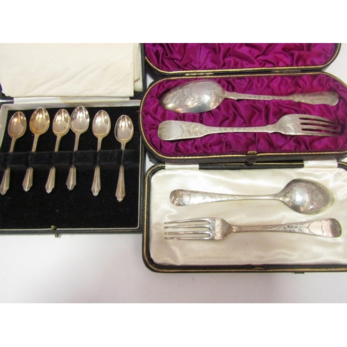 1303 - Two silver christening sets together with a set of silver coffee spoons, all cased