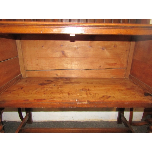 1025 - A 1920's oak full height dresser, plate rack top over a two door cupboard base, bobbin supports, 200... 