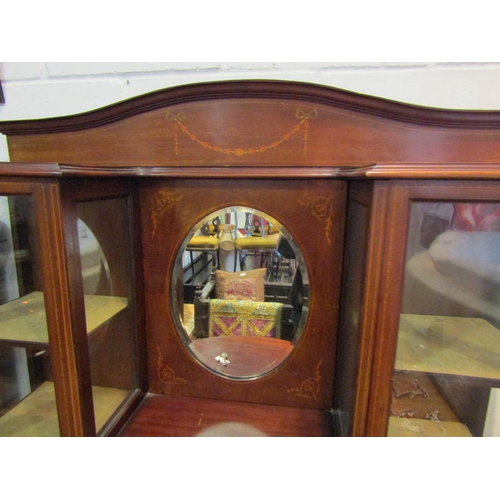 1027 - An Edwardian mahogany full height display cabinet with bow front and oval mirror, inlaid ribbon and ... 