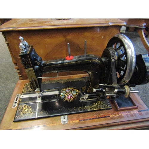 1029 - A walnut cased Singer sewing machine