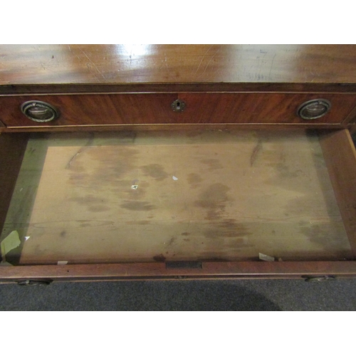 1049 - A 19th Century mahogany bureau, the fall front over four long drawers, oval brass urn relief handles... 