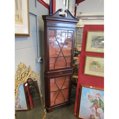 1083 - An Edwardian inlaid mahogany astragal glazed two door corner cabinet with key, the swan neck pedimen... 