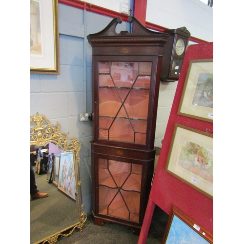 1083 - An Edwardian inlaid mahogany astragal glazed two door corner cabinet with key, the swan neck pedimen... 